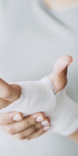 Woman with gauze bandage wrapped around her hand